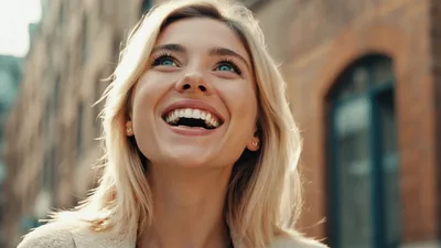 Happy Blonde Woman Laughing Outdoors