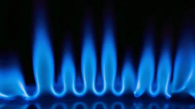 Blue Gas Stove Flames Burning In Dark Kitchen