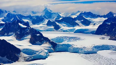Aerial View Of Massive Antarctic Glacier And Mountain Range