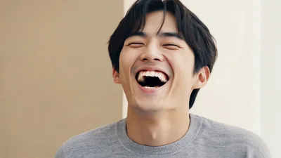 Young Asian Man Laughing Joyfully In Studio