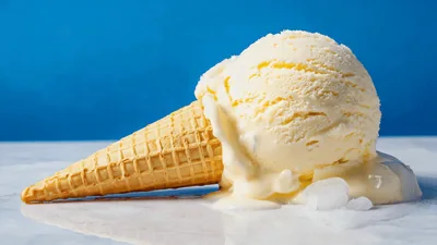 Vanilla Ice Cream Cone Melting On White Surface