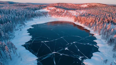 Aerial View Of A Frozen Lake In Winter Forest