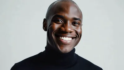 Portrait Of A Smiling Black Man In Turtleneck
