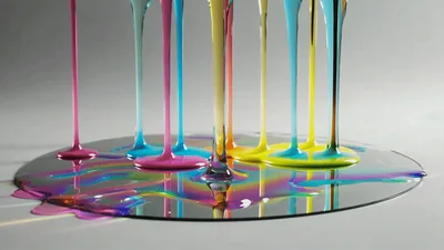 Colorful Viscous Liquids Dripping Onto A Reflective Surface