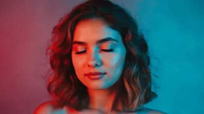 Young Woman With Neon Lighting Looking At Camera