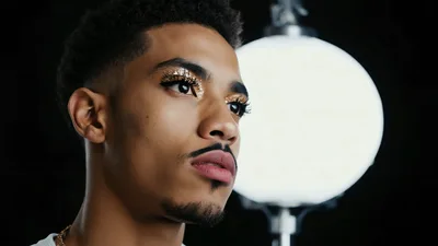 Young Man With Gold Glitter Eyeshadow Posing