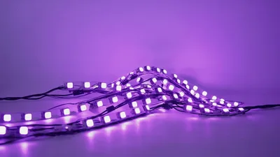 Purple LED Strip Lights Glowing On White Surface