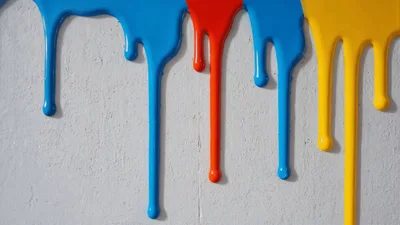 Colorful Paint Drips Running Down A White Wall