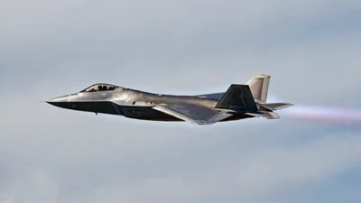F-22 Raptor Fighter Jet Flying Through Blue Sky