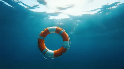 Lifebuoy Floating On The Surface Of Deep Blue Ocean