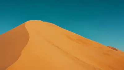 Majestic Sand Dune Under Clear Blue Sky