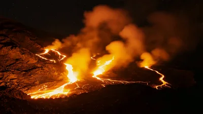 Active Volcanic Eruption With Glowing Lava Flows At Night