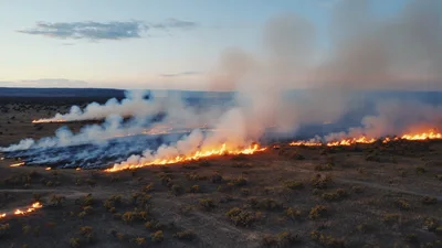 Aerial View Of A Wildfire Burning Across Dry Grassland