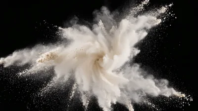 White Powder Explosion Against Black Background