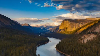 Aerial View Of A Winding River Through A Mountain Valley