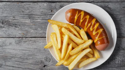 Grilled Sausage With Mustard And French Fries On Plate