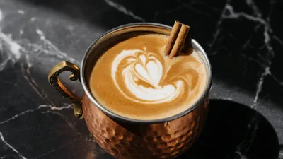 Copper Mug Of Latte With Cinnamon Stick