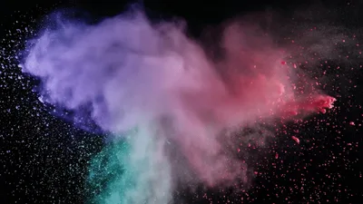Colorful Powder Explosion Against Black Background
