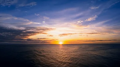 Vibrant Sunset Over The Calm Ocean Horizon