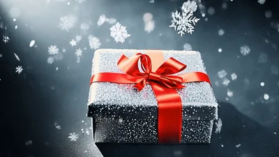 Silver Gift Box With Red Ribbon Under Falling Snow