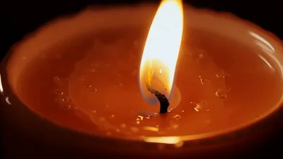 Single Candle Flame Burning In The Dark