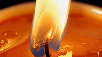 Close Up Of A Burning Candle Wick