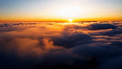 Aerial View Of Golden Sunrise Above Thick Clouds