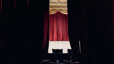 Red Velvet Curtains Opening On An Empty Theater Stage