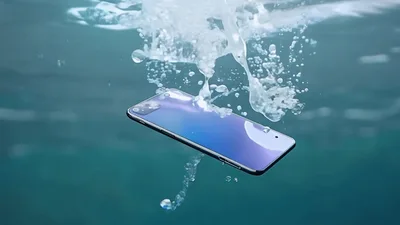 Smartphone Falling Into Clear Blue Ocean Water
