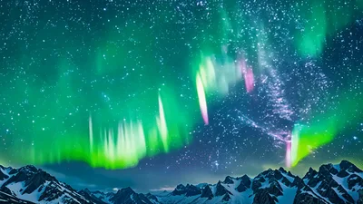 Vibrant Aurora Borealis Dancing Over Snowy Mountain Peaks