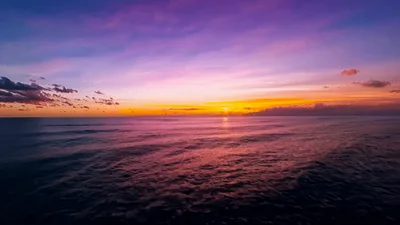 Aerial View Of Tropical Ocean Sunset Over Horizon