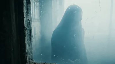 Mysterious Hooded Figure Walking Through Foggy Abandoned Building