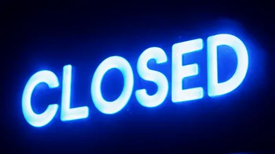 Bright Blue Neon Closed Sign Glowing In The Dark