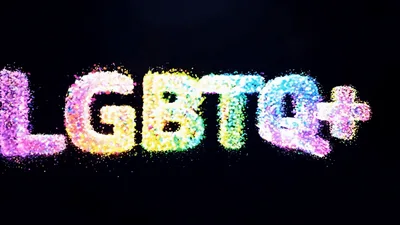 Colorful LGBTQ Plus Text Formed By Glowing Particles