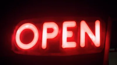 Red Neon Open Sign Flickering In The Dark