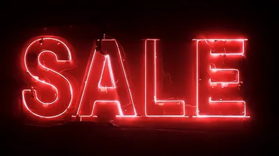 Bright Red Neon Sale Sign Glowing In The Dark