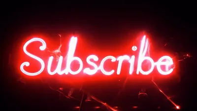 Red Neon Subscribe Sign Flickering In Dark Room