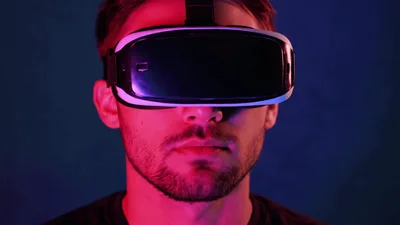 Young Man Wearing Virtual Reality Headset Under Neon Lighting