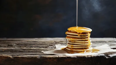 Maple Syrup Pouring Over A Stack Of Hot Pancakes
