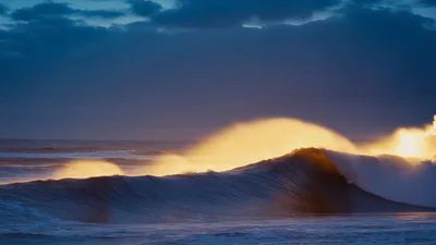 Golden Ocean Wave Crashing At Sunset