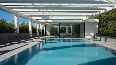 Modern Swimming Pool With Pergola In Sunny Backyard