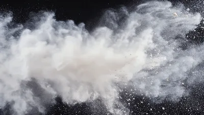 White Powder Explosion Against Black Background