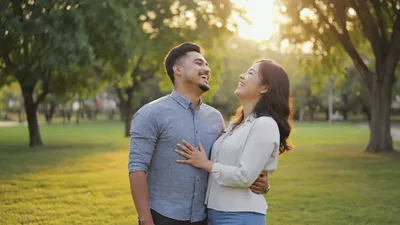 Happy Young Couple Laughing Together In A Park