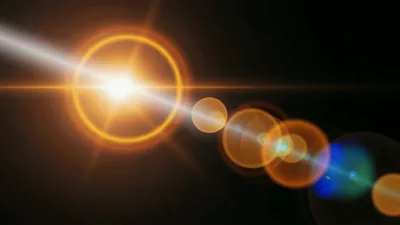 Bright Golden Lens Flare Effect On Black Background