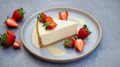 Slice Of Cheesecake With Fresh Strawberries On Plate
