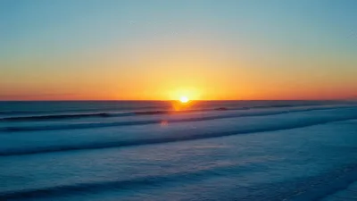 Golden Sunset Over Rolling Ocean Waves