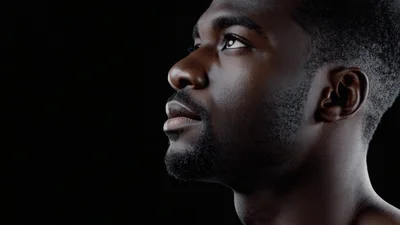 Profile View Of A Young Black Man Looking Up