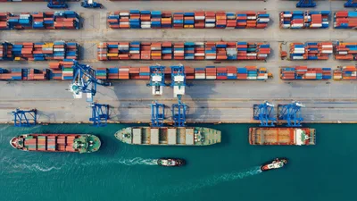 Aerial View Of Cargo Ships And Tugboats At Port
