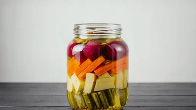 Glass Jar Filled With Pickled Vegetables On Table