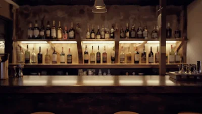 Empty Bar Counter With Illuminated Liquor Bottle Shelves